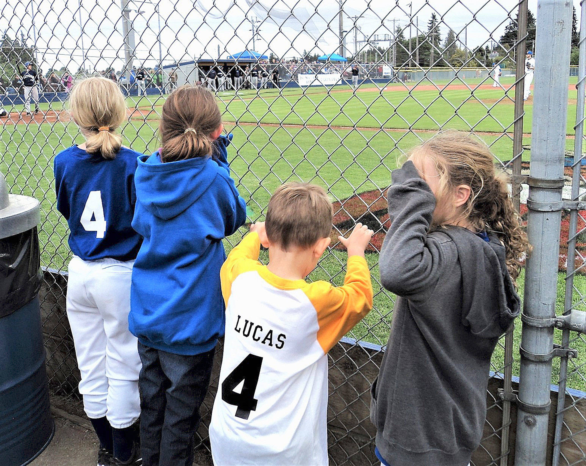 From left Ava Fox, Catie Chance, Lucas Chance and Addison Fox get up close to the action and the players at the Port Angeles Lefties’ inaugural game. (Pierre LaBossiere/Peninsula Daily News)