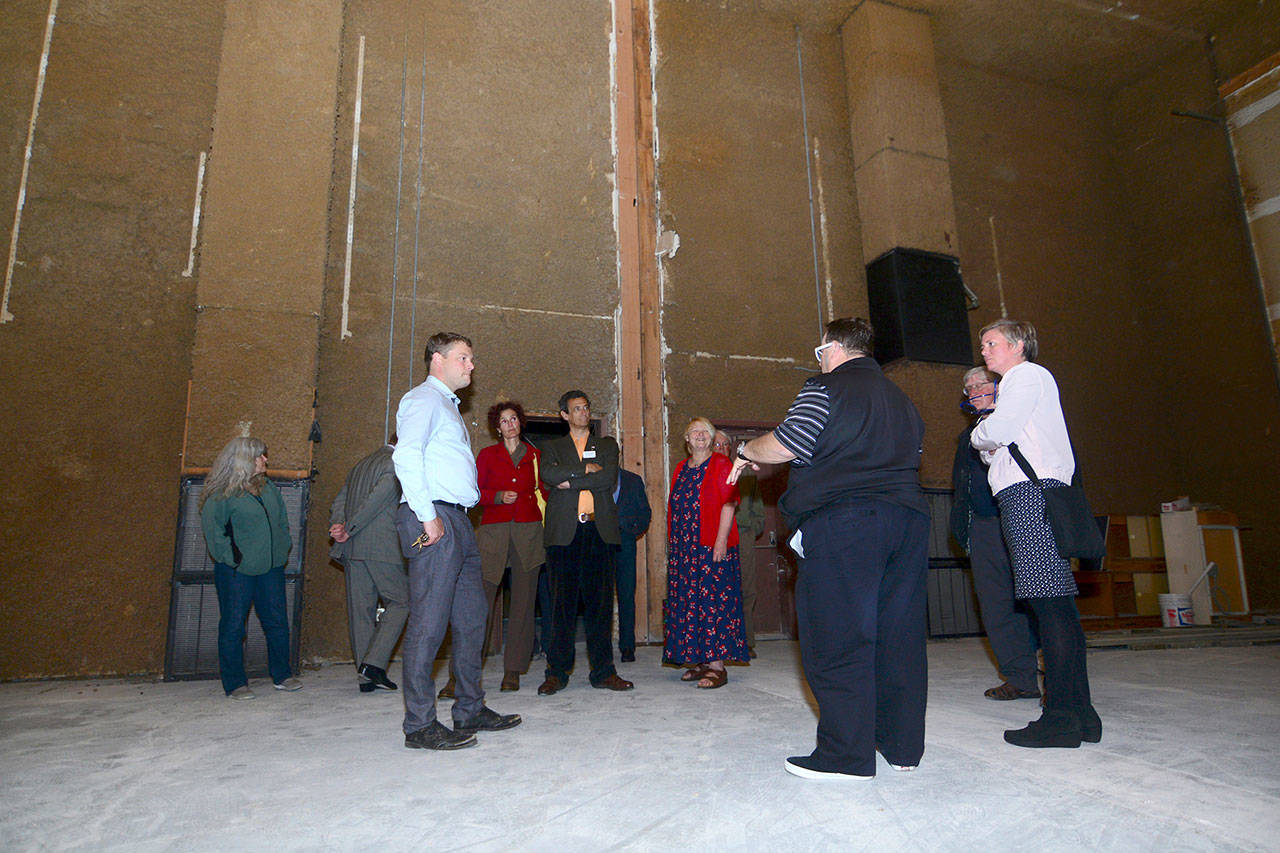 A group tours the former Lincoln Theater, which Jacob Oppelt hopes to revive as a performance venue within the next year, following the Port Angeles Regional Chamber of Commerce luncheon on Wednesday. (Jesse Major/Peninsula Daily News)