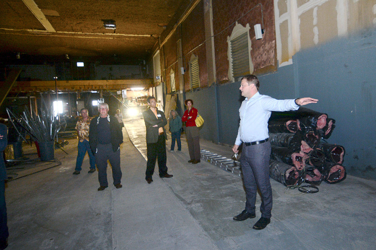 Jacob Oppelt leads a tour of the former Lincoln Theater, which he hopes to revive as a performance venue within the next year, following the Port Angeles Regional Chamber of Commerce luncheon on Wednesday. (Jesse Major/Peninsula Daily News)