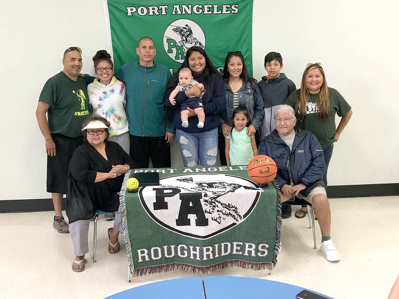 Port Angeles Roughrider Nizhoni Wheeler’s family was on-hand Friday as she signed a letter of intent to play both basketballand softball at Lower Columbia Community College in Longview. Wheeler was an all-Olympic league basketball player for theRoughriders her senior season and she was the Olympic League 2A Division MVP in softball. From left back row are LesterMoses, Cheyenne Wheeler, Jason Wheeler, Nizhoni Wheeler, Jarison Moses, Rachelle Wheeler, Skylar Wheeler, Quanah Wheelerand Michelle Charles. Sitting, from left, are Alyce Charles and Frank Charles.