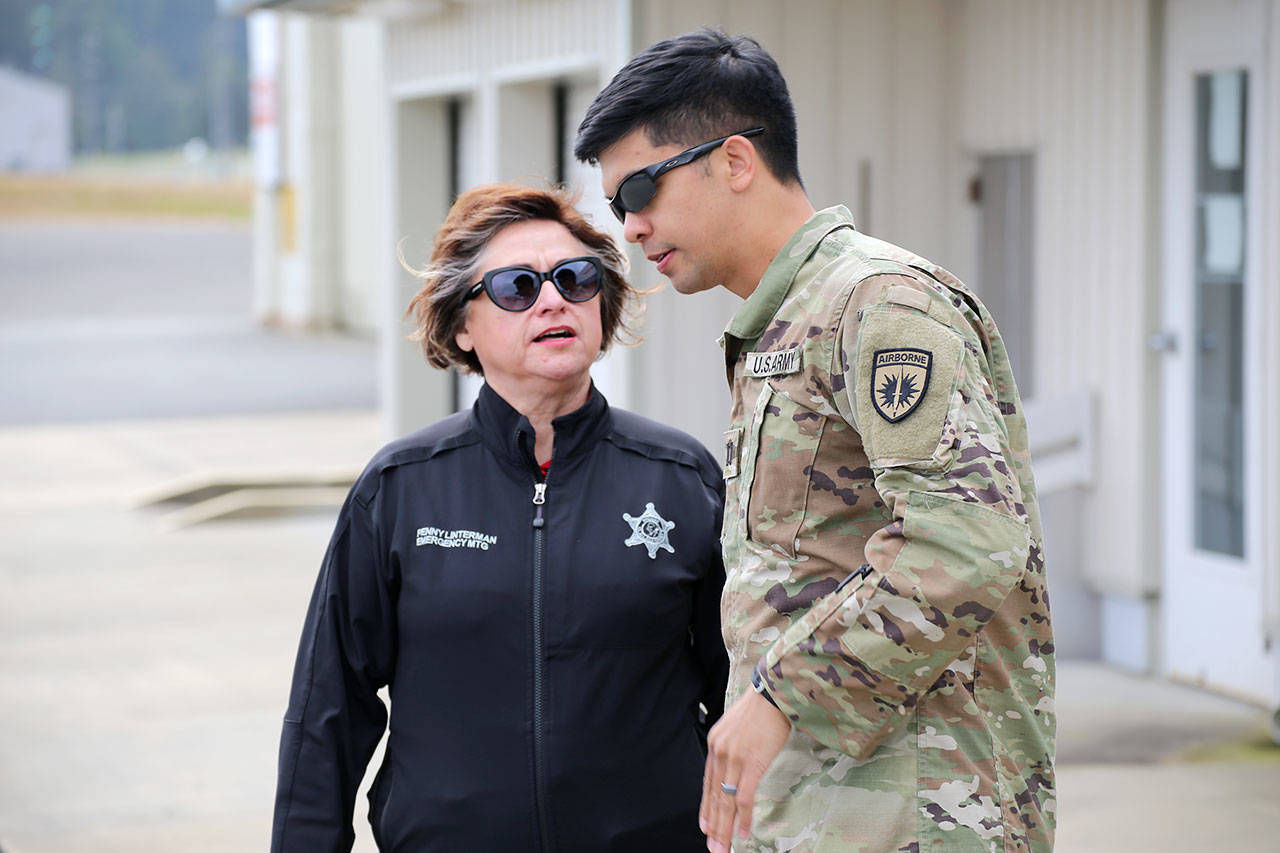 Penny Linterman, Emergency Management Program Coordinator, Clallam County Sheriff’s Office, and Capt. Dominique Calata, force protection plans officer, Special Operations Detachment-Pacific, discuss the operations at the William Fairchild Airport.