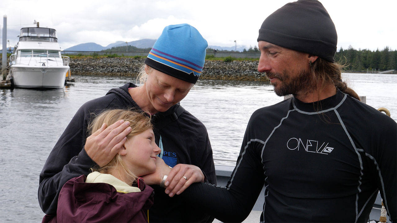 Karl Kruger reunited with his wife, Jessica, and daughter, Dagny, as he arrived Sunday on the dock in Ketchikan, Alaska as the first person to complete the 750-mile Race to Alaska on a paddle board. (Zach Carver/R2AK)
