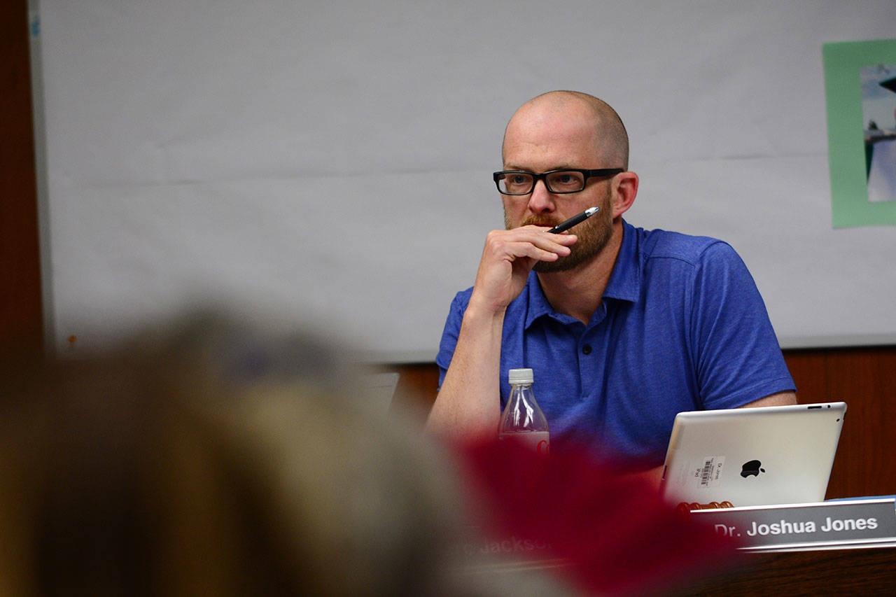 Port Angeles School Board President Josh Jones listens to public comment about the proposed health center at Port Angeles High School during the board’s meeting Thursday. The school board approved pursuing a health center in a 4-to-1 vote. (Jesse Major/Peninsula Daily News)