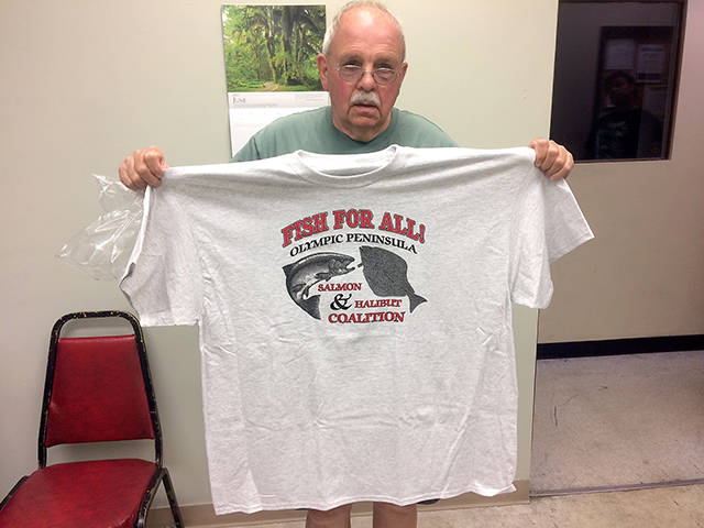 Olympic Peninsula Salmon & Halibut Coalition member Norm Metzler shows the shirt the group is selling to raise funds for travel to attend fishing meetings. Anglers can pick up the shirts for $20 at Jerry’s Bait and Tackle and Roadrunner 76 in Port Angeles.