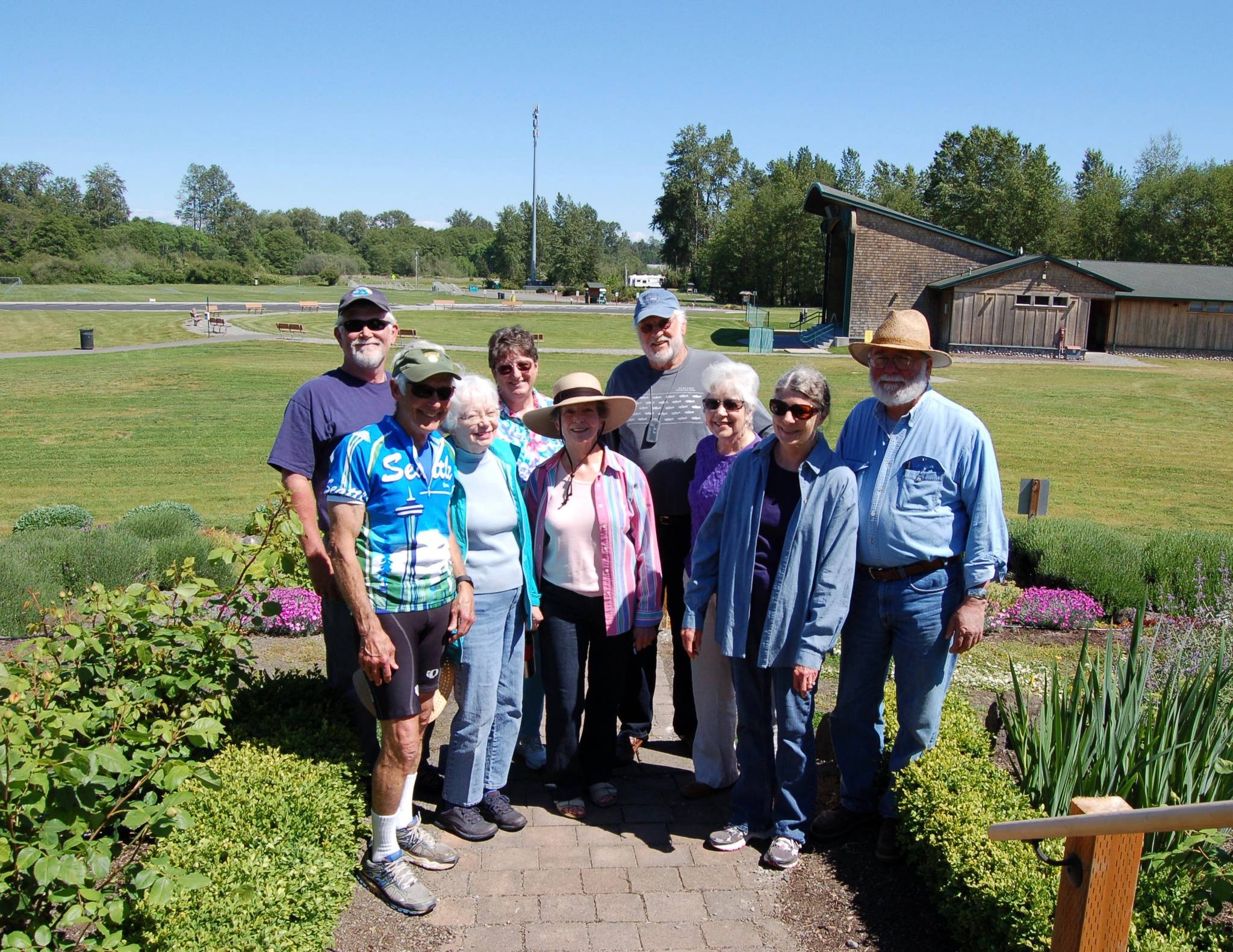 Erin Hawkins/Olympic Peninsula News Group                                Members of the Sequim Botanical Gardens Society — Lee Bowen, Dona Brock, Jean Pier, Donni Hatlestad, Kathy Pitts, John Hassel, Maryann Ballard, Stu Hemstreet and Andy Pitts — stand where a pergola will be landscaped in as part of the planned rose garden that will be an addition to the Sequim Botanical Gardens.