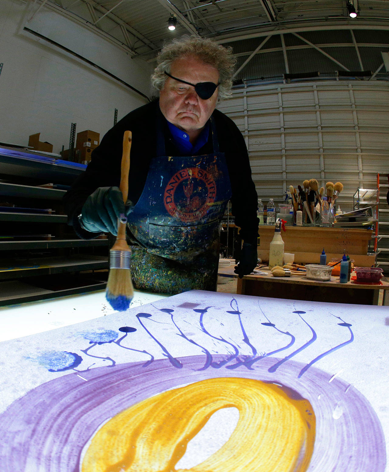 Glass artist Dale Chihuly works on a piece titled “Glass on Glass” in one of his studios in Seattle in March. (Ted S. Warren/The Associated Press)