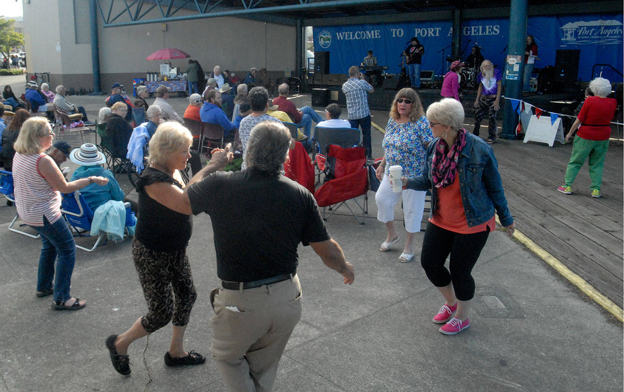 Audience members dance at a recent installment of the Concert on the Pier music series at Port Angeles City Pier. (Keith Thorpe/Peninsula Daily News)