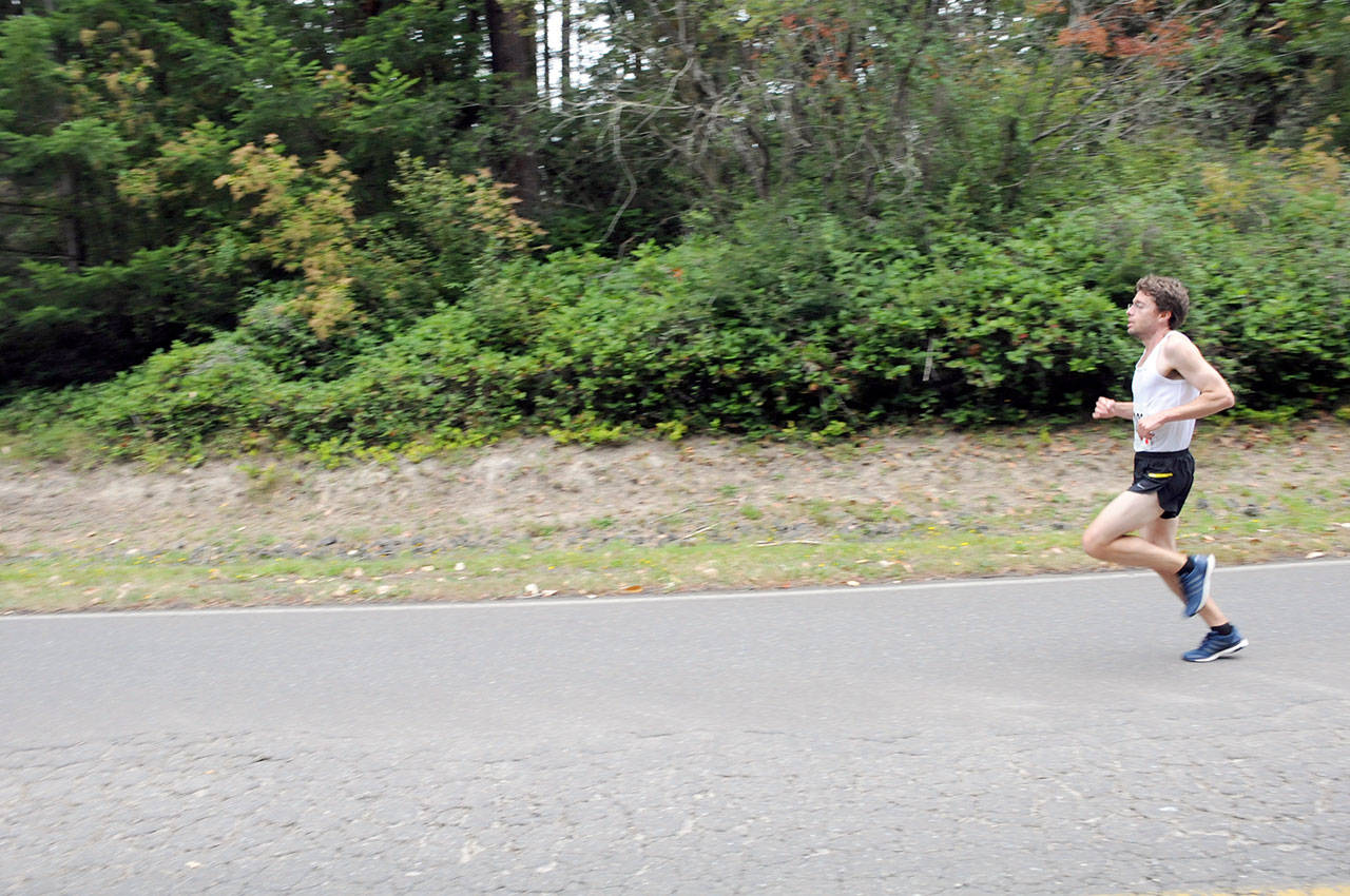 Dylan Diras, last year’s 5K Deer Run winner, races along the roads on Naval Magazine Indian Island. The race is one of the few times each year that the general public is invited onto the base. (NAVMAG Indian Island)
