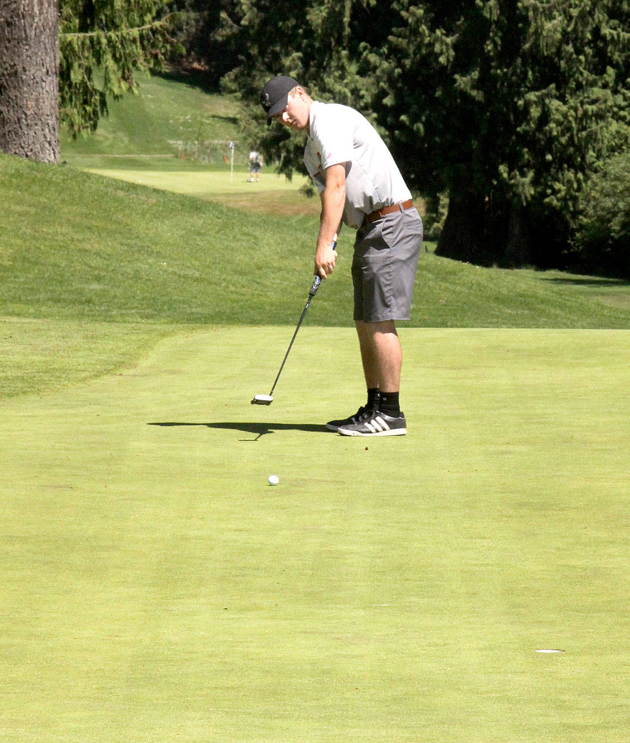 Dave Logan/for Peninsula Daily News                                Jack Shea, 19, putts on the 18th hole at Cedars at Dungeness Sunday to win the three-day Clallam County Amateur Golf Tournament with scores of 70-69-72 for a 211. Shea, a Sequim High School golfer who graduated in 2016, has won the event two years in a row.