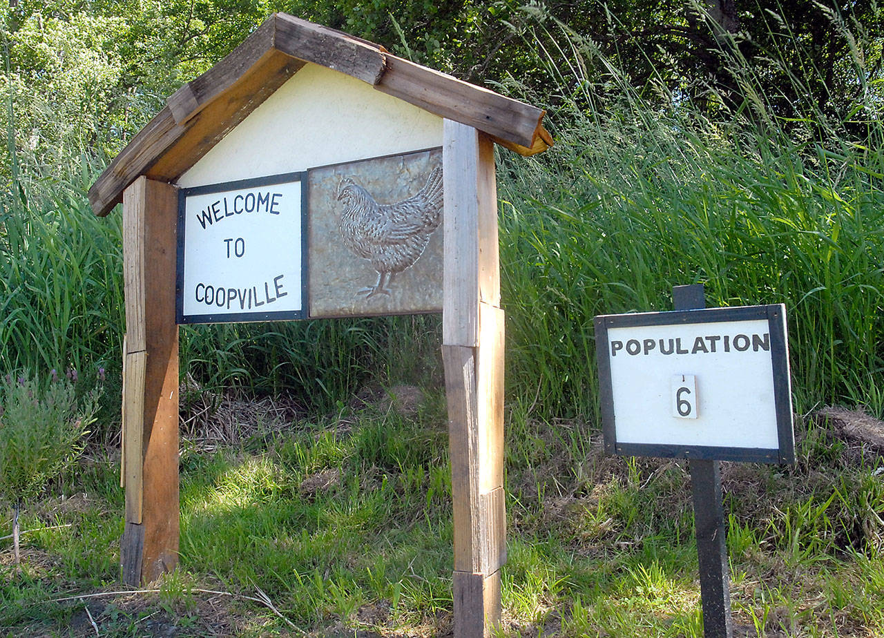 A sign welcomes visitors to Coopville, a small town built for chickens. (Keith Thorpe/Peninsula Daily News)