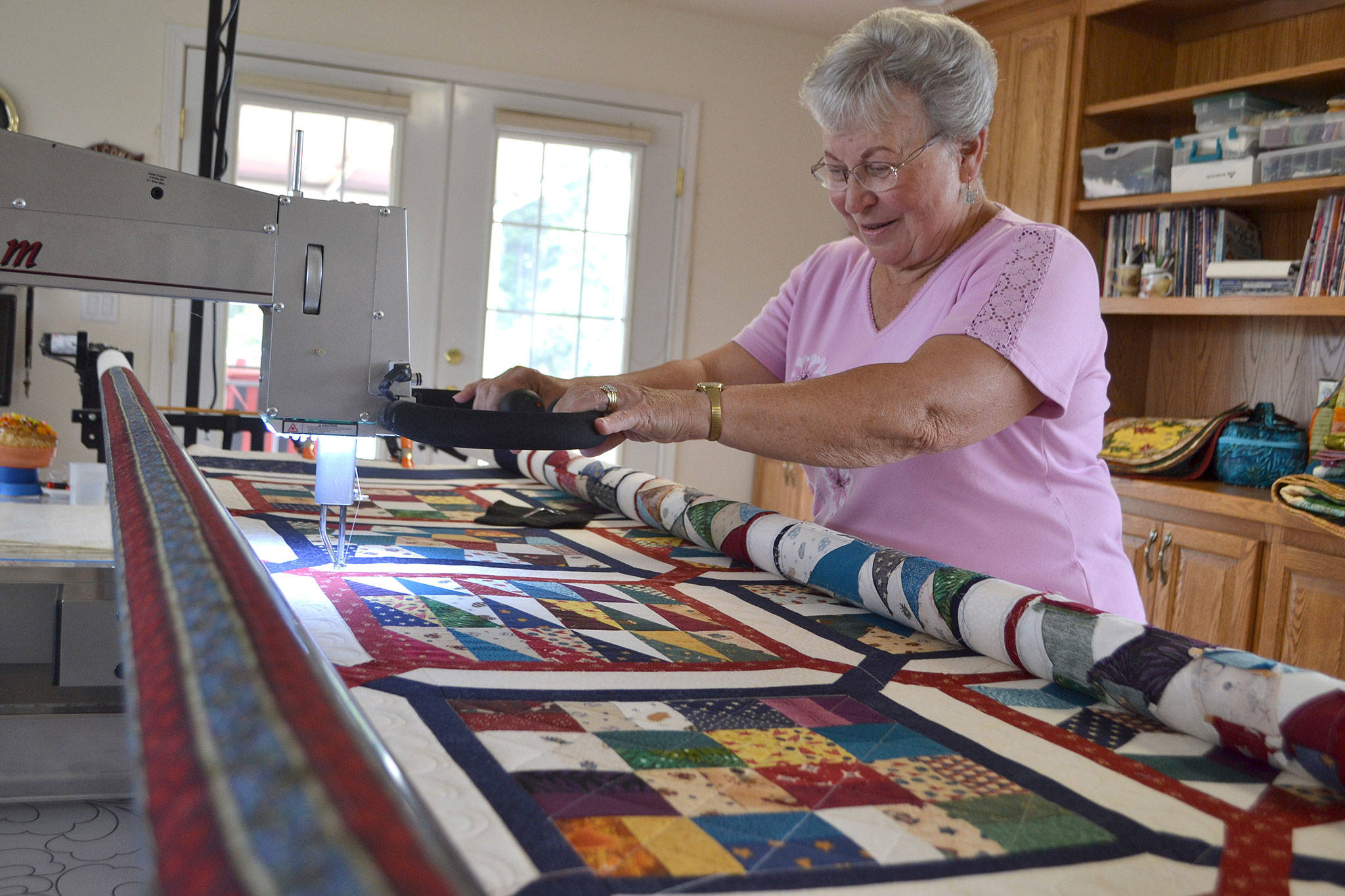 Glaucoma has made it difficult for Murph Gerber to continue longarm quilting, but she continues to work in the medium and with other quilts a few days a week, she says. (Matthew Nash/Olympic Peninsula News Group)
