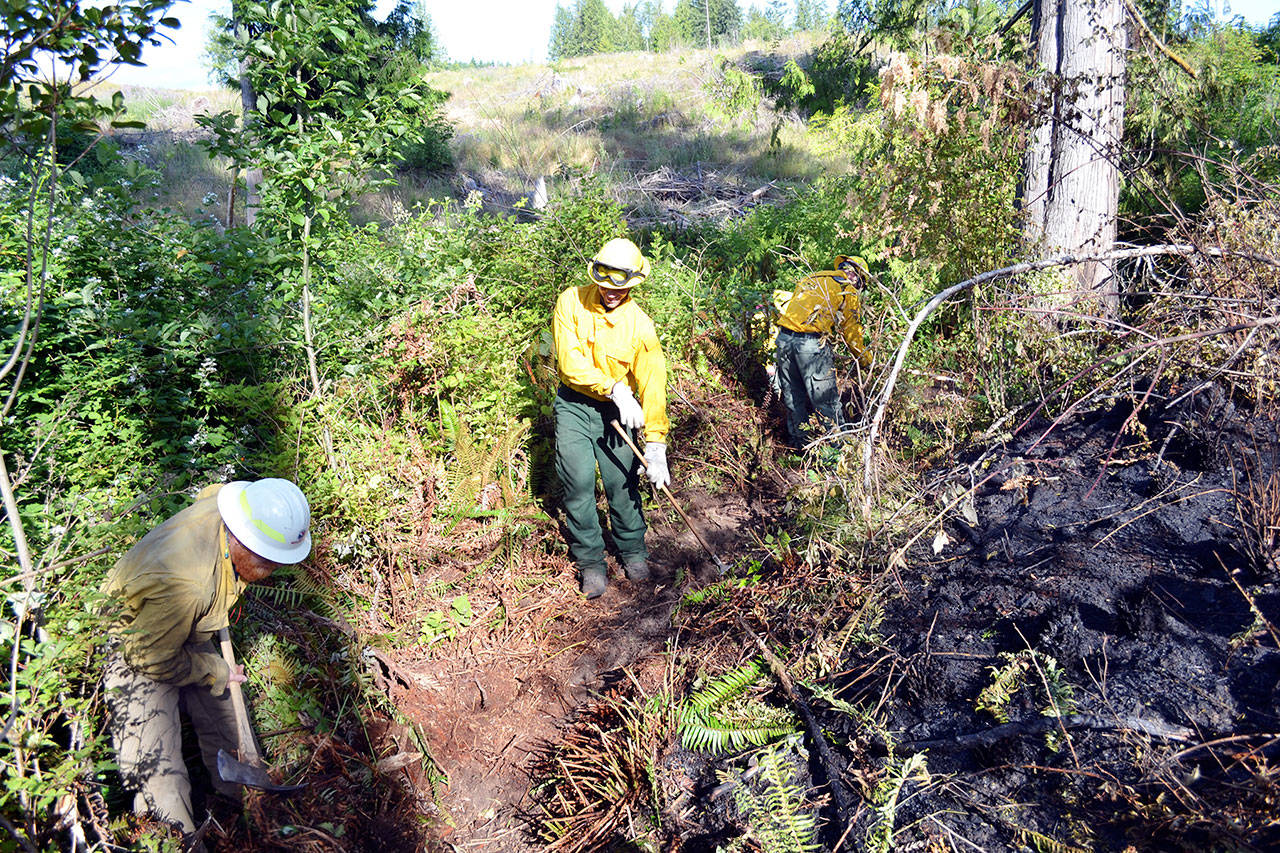 State Department of Natural Resources crews dig a fire line around the perimeter of a brush fire on Sommerville Road in Chimacum. (Bill Beezley/East Jefferson Fire-Rescue)