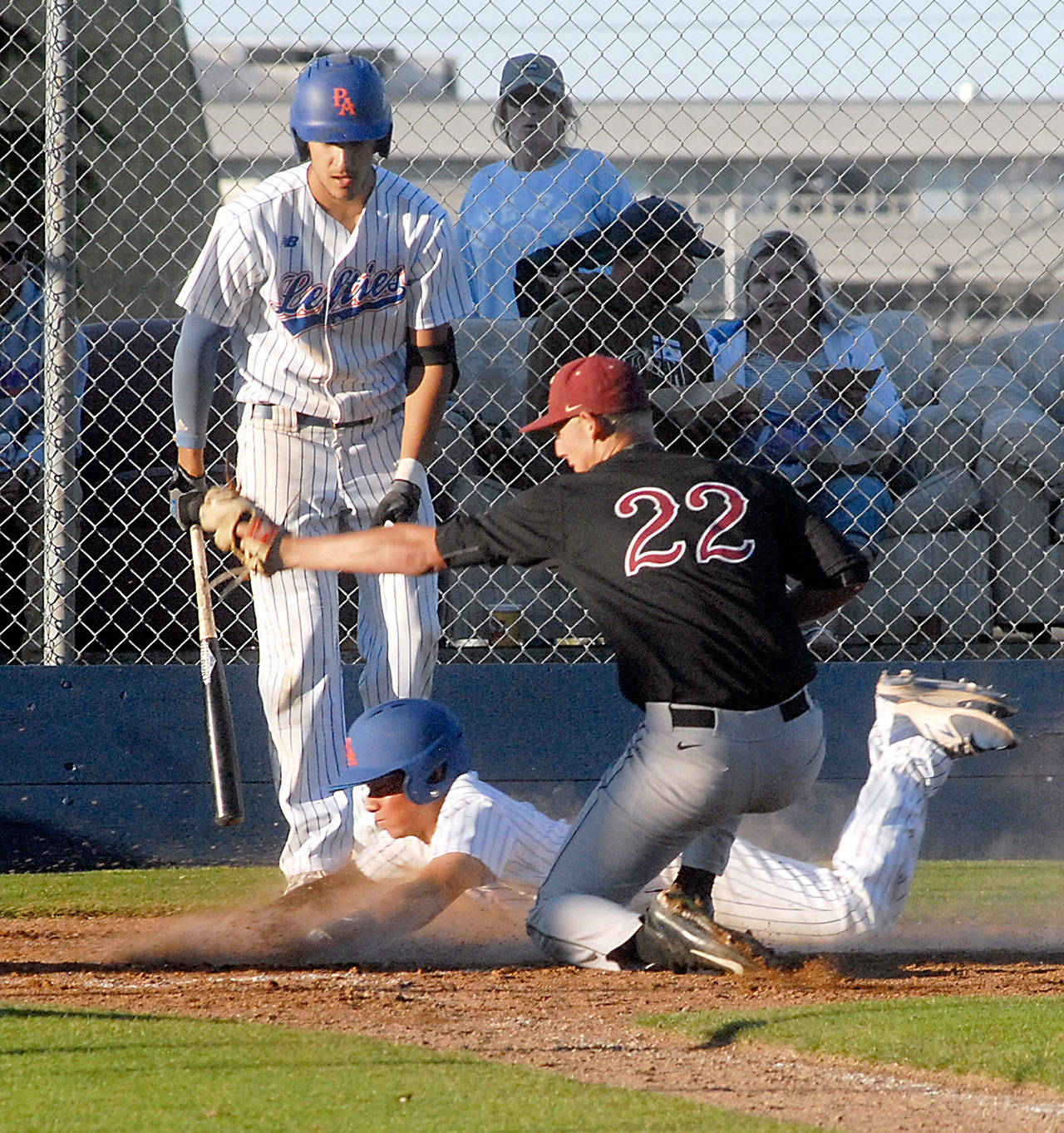 Lefties’ Austin Tengan successfully steals home after a wild pitch to Lefties batter Ian Nowak by Corvallis pitcher Cameron Richman, right, slipped past the catcher in the second inning on Friday night at Port Angeles Civic Field.                                Keith Thorpe/Peninsula Daily News