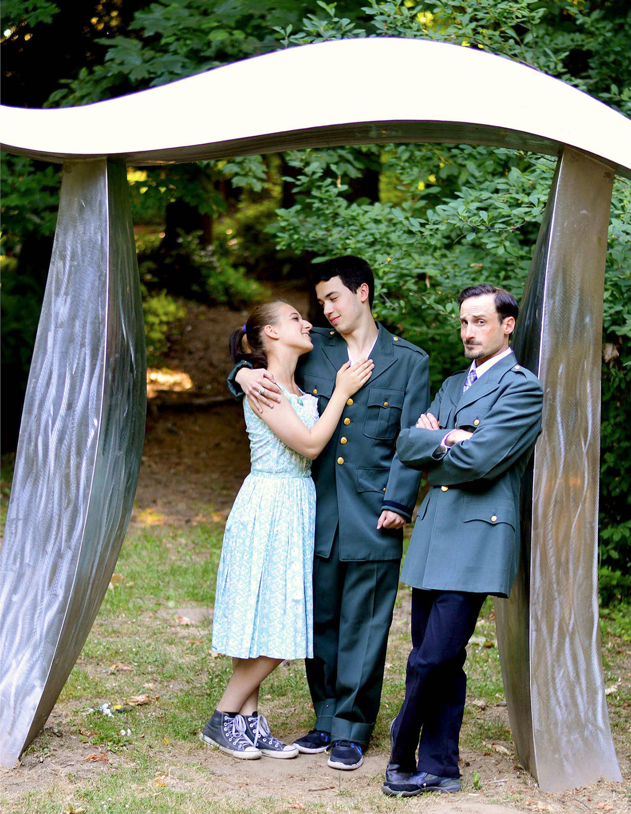 From left, Samantha Weinert, Brad Alemao and Josh Sutcliffe appear, along with the Webster’s Woods “Pi a la Mode” sculpture, in “Much Ado about Nothing.” The Shakespeare in the Woods romantic comedy plays in the woods at the Port Angeles Fine Arts Center each weekend beginning today through Sunday, Aug. 6. (Diane Urbani de la Paz/for Peninsula Daily News)