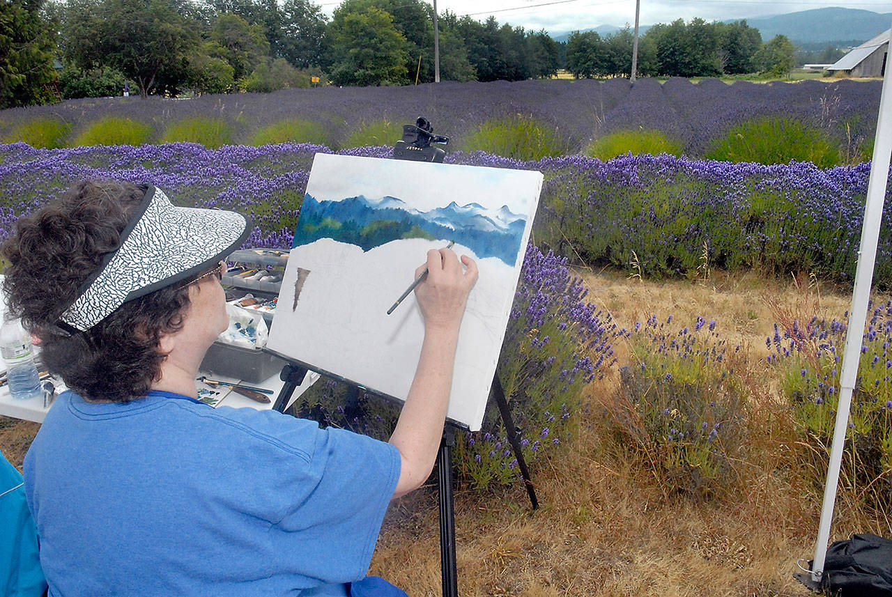 Artist Susy Halverson of Longview paints a vista of lavender and mountains at the B&B Family Farm during Sequim Lavender Weekend on Friday. (Keith Thorpe/Peninsula Daily News)