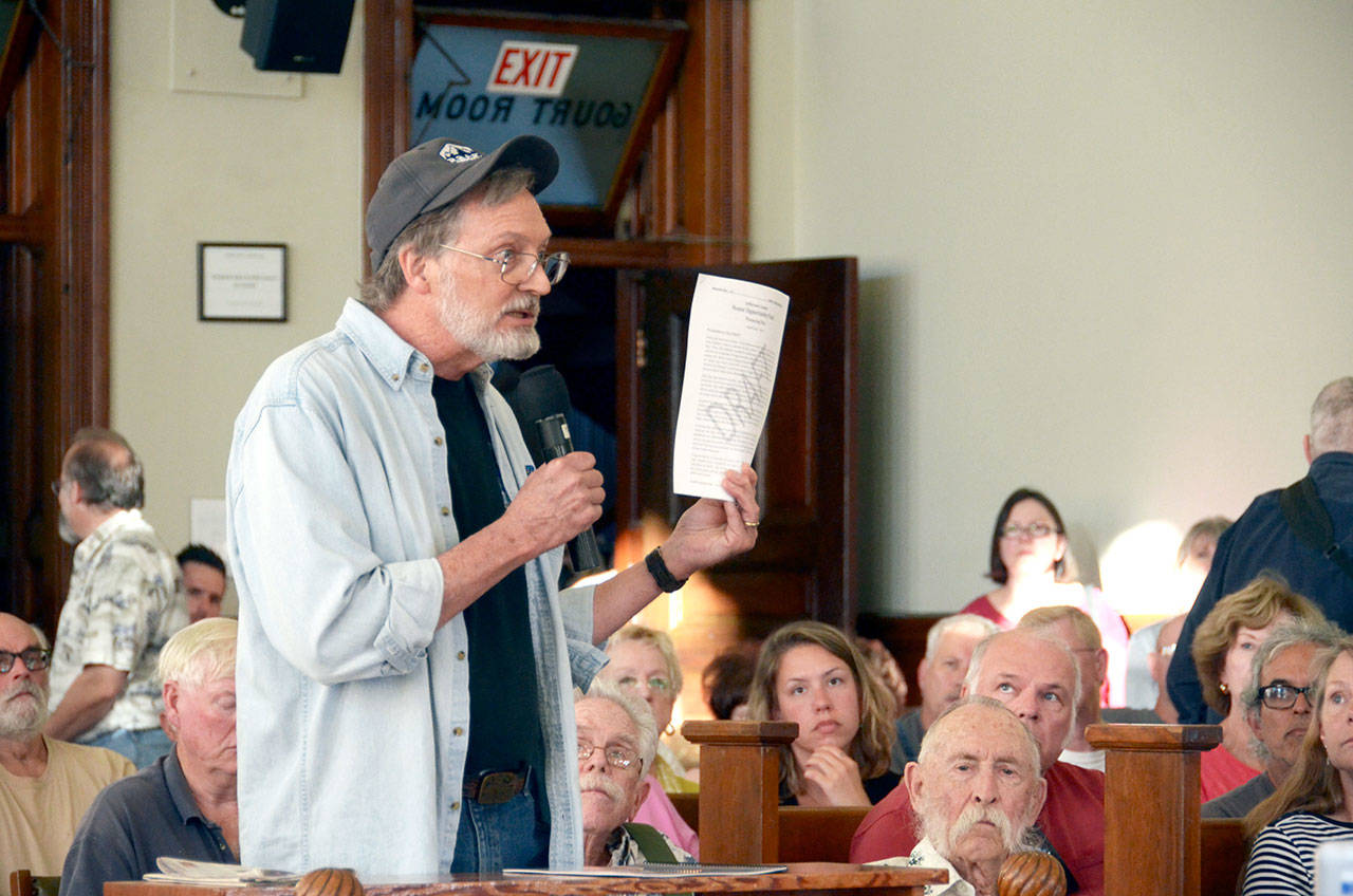 Dan Nieuwsma of Port Townsend expresses some concerns he has about a proposed property tax levy at a public hearing that was attended by over 100 community members Monday night. (Cydney McFarland/Peninsula Daily News)