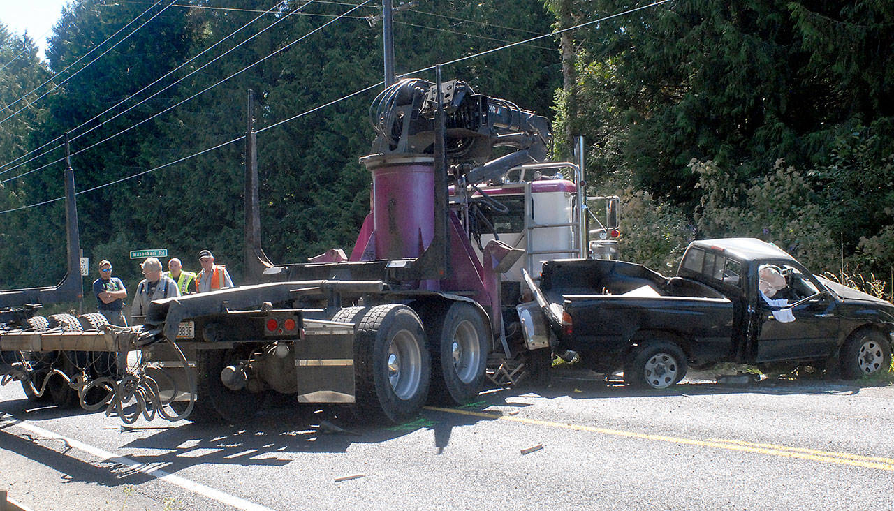 An empty log truck blocks state Highway 112 at Wasankari Road west of Port Angeles after colliding with a pickup truck Friday. (Keith Thorpe/Peninsula Daily News)