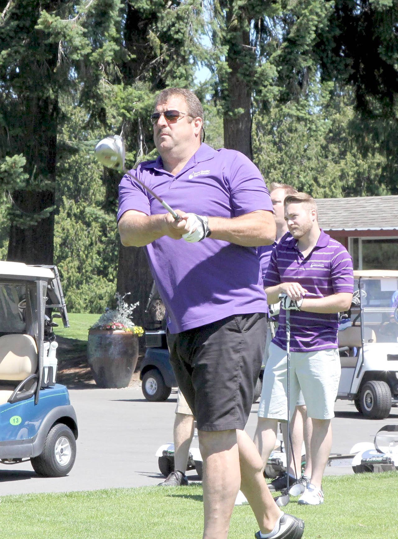 Port Angeles resident Scott Jones tees off on the first hole of the seventh annual Sonny Sixkiller Husky Golf Classic presented by Wilder Auto Center. Jones, a Port Angeles and University of Washington graduate, is the only Roughrider to have played in the NFL. A total of 39 teams and 195 golfers played in the event. The winning team of Todd Negus, Paul Reed, Jordan Negus and Chad Wagner shot a 17-under-par 55 in the scramble event. The team also had former Husky men’s basketball player John Buller. (Dave Logan/for Peninsula Daily News)