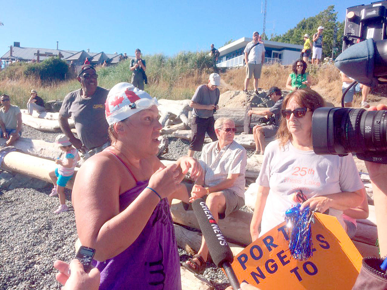 Susan Simmons of Victoria talks to news media after becoming the eighth person known to swim across the Strait of Juan de Fuca on Monday. (Travis Paterson/Saanich News)