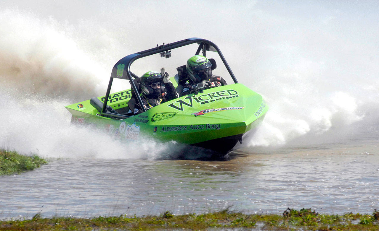 Keith Thorpe/Peninsula Daily News A Wicked Racing sprint boat piloted by Dan Morrison and navigated by Cara McGuire powers through the Extreme Sports Park course during races in July 2016.
