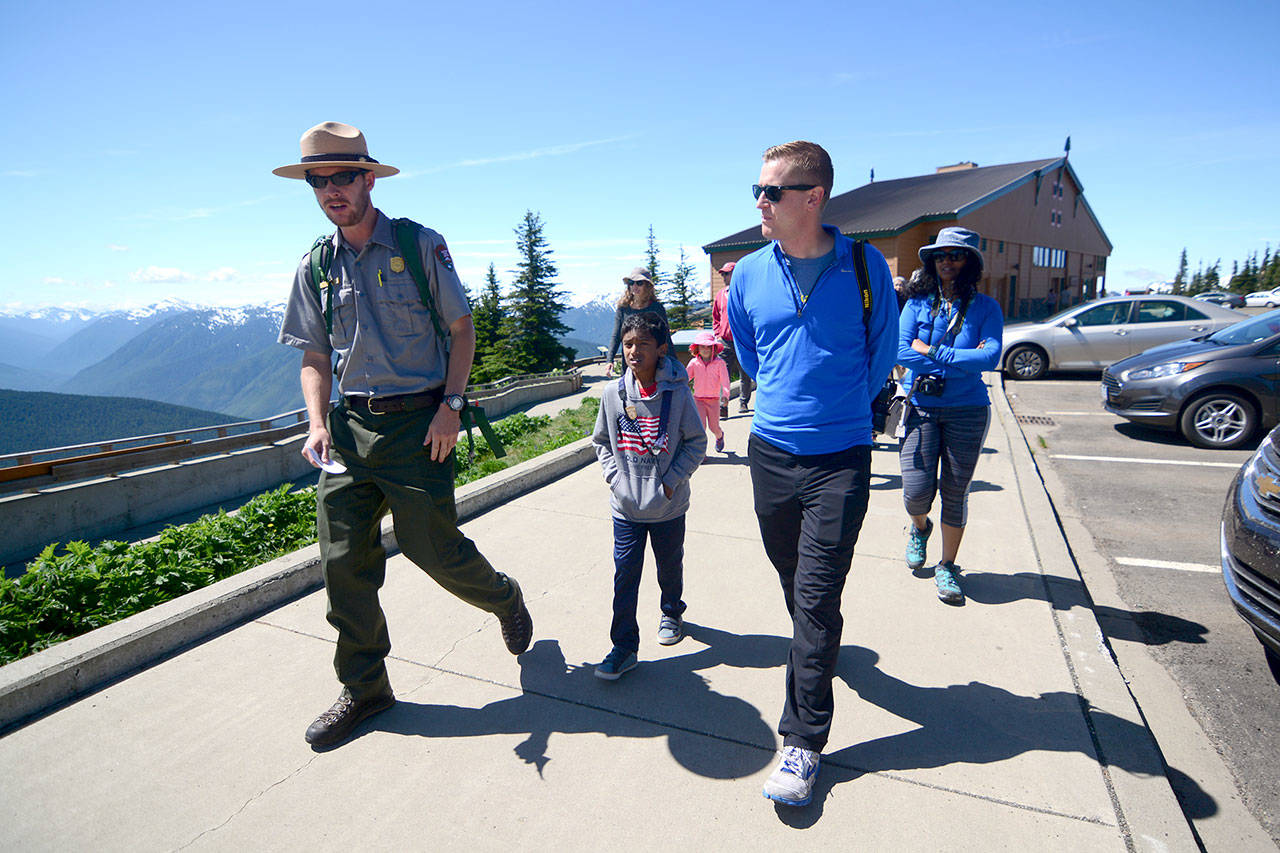 Mikah Meyer, 31, right, chats with a ranger at Hurricane Ridge on Wednesday. (Jesse Major/Peninsula Daily News)