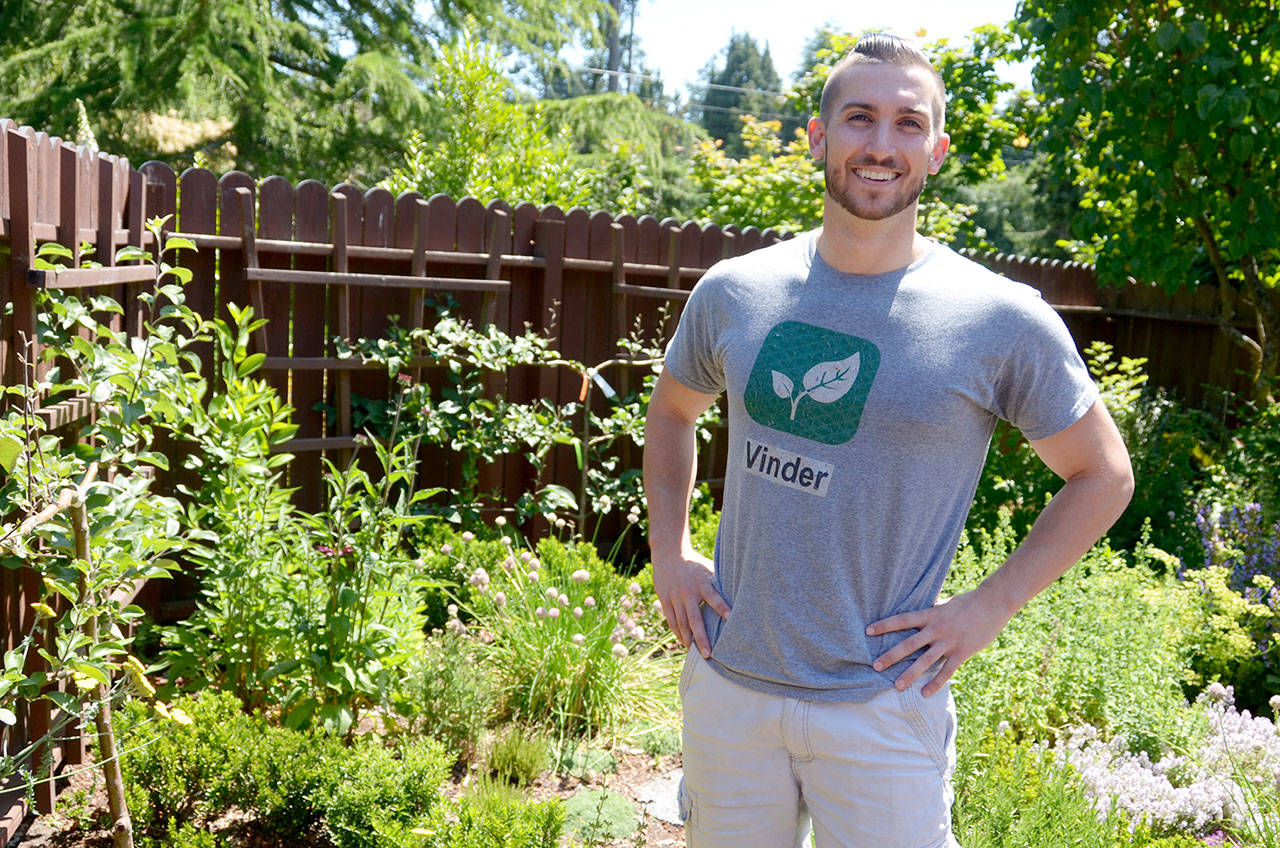 Sam Lillie, founder and CEO of Vinder, stands in his backyard herb garden in Port Townsend. (Cydney McFarland/Peninsula Daily News)