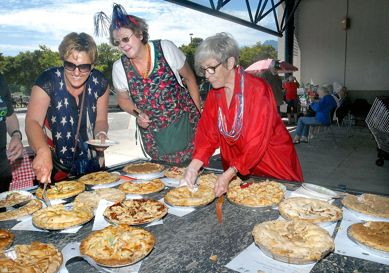Apple pie contest volunteers, from left, Sally Fulton, Iantha Frazer and Edna Petersen sort through entries prior to judging during Independence Day festivities at Port Angeles City Pier. The contest was one of several events around Port Angeles on Tuesday, including a Fourth of July parade through the downtown area and fireworks over Port Angeles Harbor. (Keith Thorpe/Peninsula Daily News)