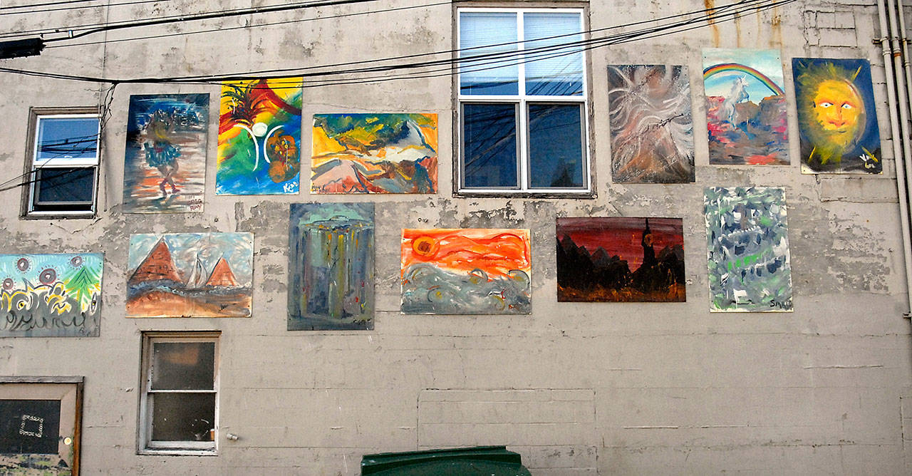 Paintings adorn the alley-side wall at the rear of Studio Bob in downtown Port Angeles. (Keith Thorpe/Peninsula Daily News)