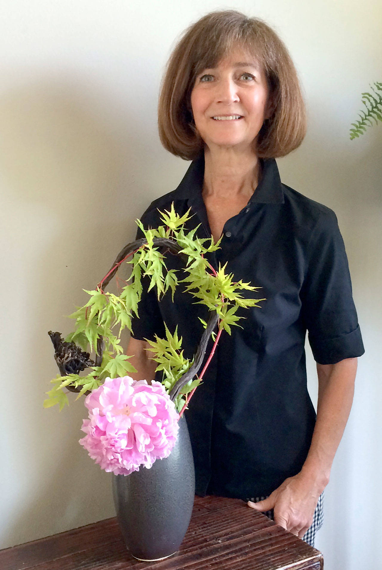 Janie Redifer shows an example of Ikebana, Japanese flower arranging.
