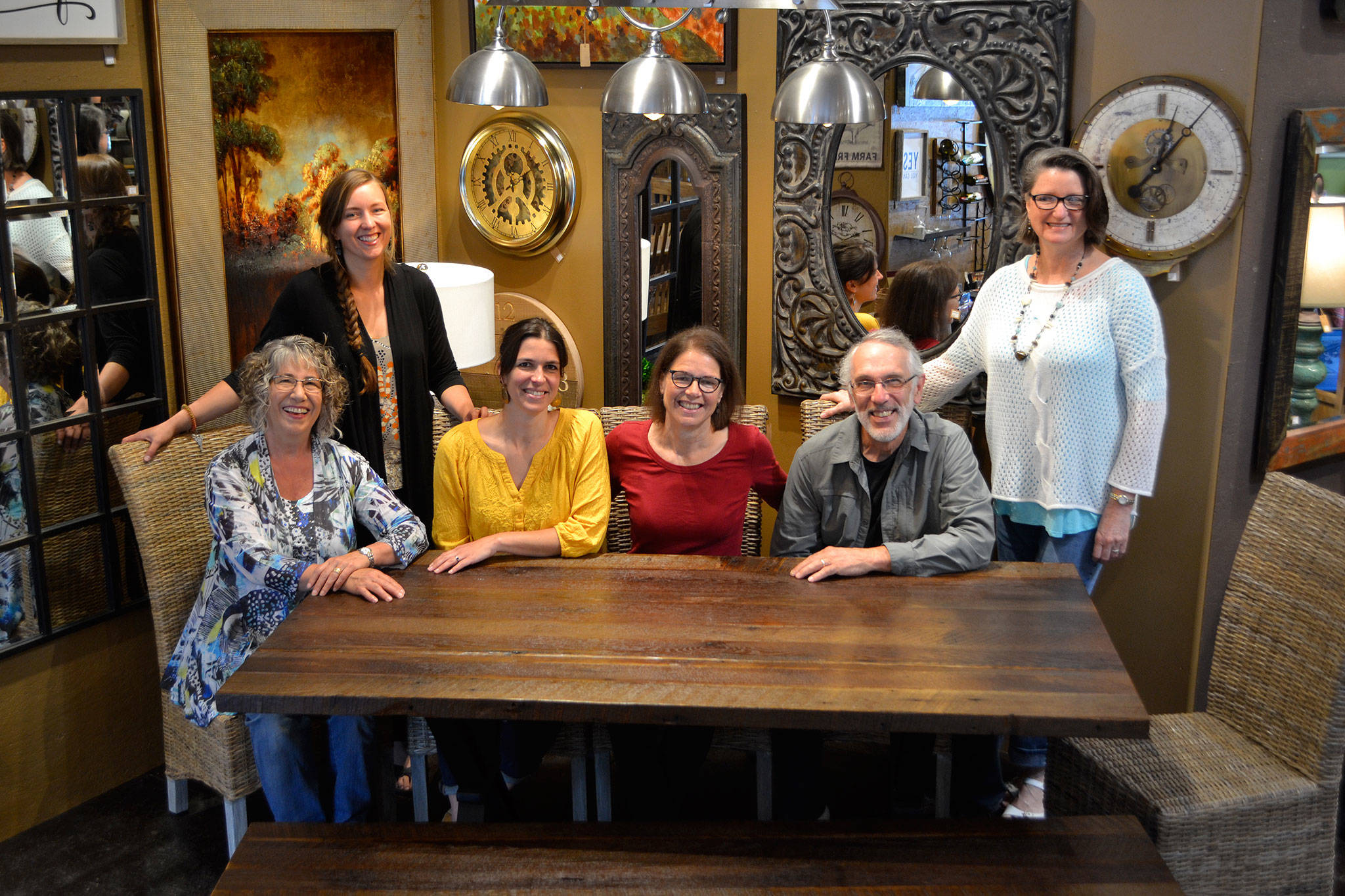 Jeri and Fran Sanford, fourth and fifth from left, recently listed their 20-year-old business, Over the Fence, for sale. They’ve offered home furnishings from around the world for more than 20 years. Staff for the store include, from left, Katy Nichols, Bergen Carey, Emily Underwood, Jeri and Fran Sanford, and Joanie May. Not pictured are Iris Edey, Cathy Lopes and Chris Biedermanngarde. (Matthew Nash/Olympic Peninsula News Group)
