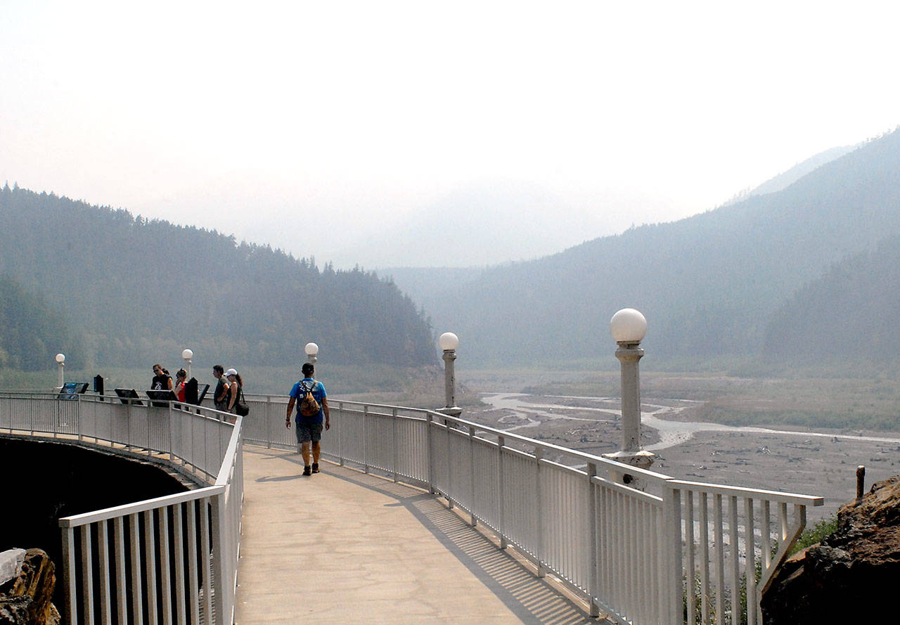 Visitors to the Glines Canyon Spillway Overlook in the Elwha Valley of Olympic National Park are greeted by a mountain vista obscured by smoke Thursday, the product of wildfires in British Columbia. (Keith Thorpe/Peninsula Daily News)