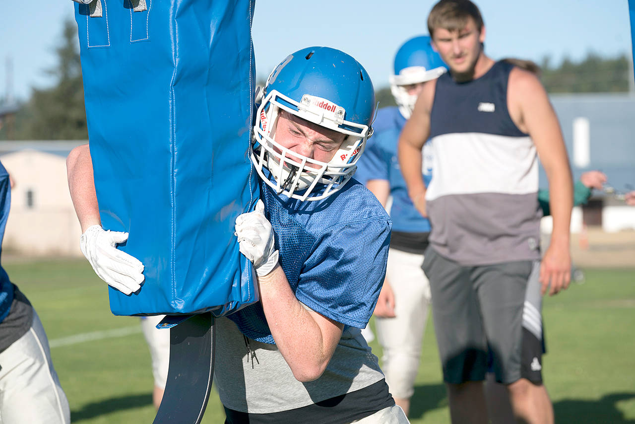 Chimacum&rsquo;s Isaac Purser hits the tackling sled during a recent preseason practice. Steve Mullensky/for Peninsula Daily News