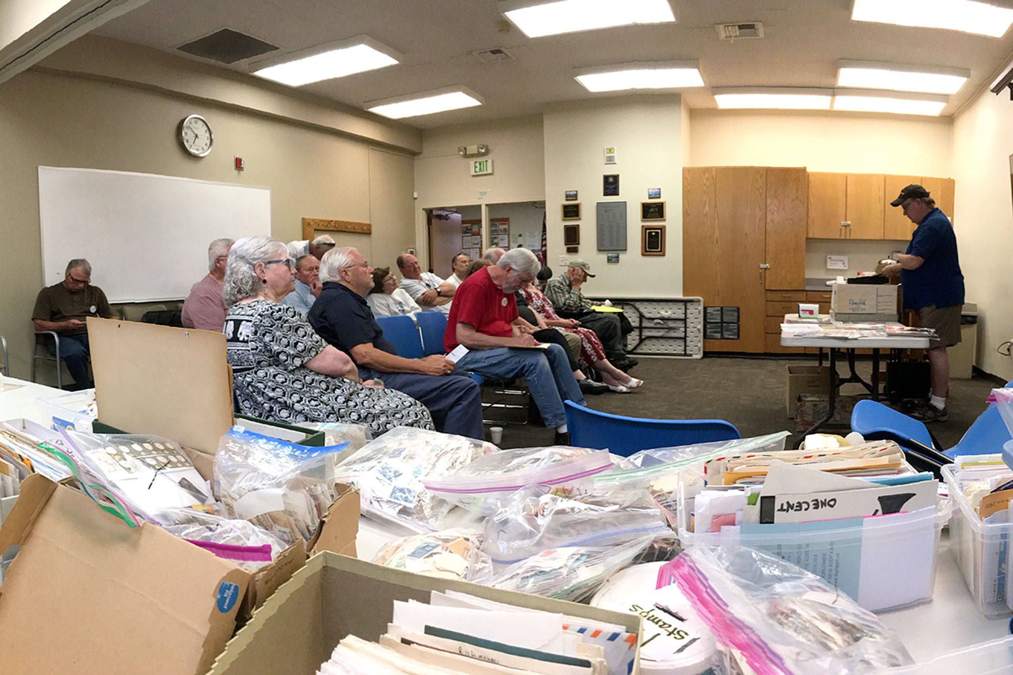 Strait Stamp Society members gather Aug. 2 in the Sequim Library for their monthly meeting. There they discussed logistics for their 24th annual show Saturday and some of their recent discoveries while collecting. (Matthew Nash/Olympic Peninsula News Group)