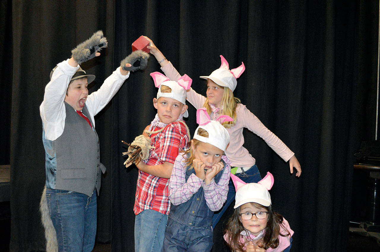 The Big Bad Wolf, played by Finn Waknitz, threatens to blow down the houses of the three little pigs, played by Nicholas Burke, Madeline Irwin, Mabel Waknitz and Piper Wikert. (Brandi Welch)