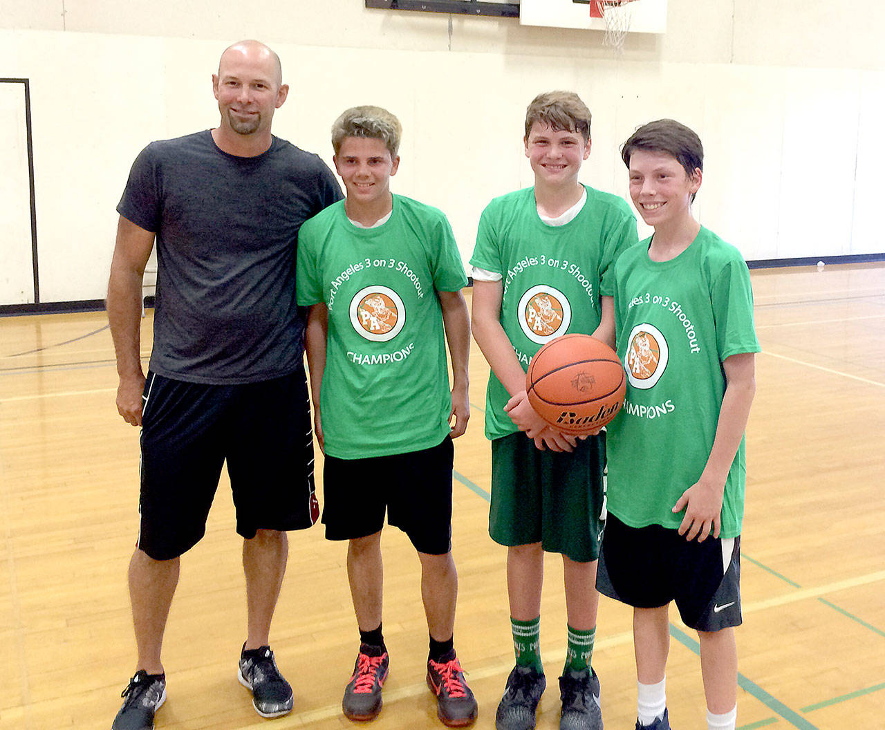 This trio of young hoopsters won the 3-on-3 tournament put on during the Port Angeles High School Basketball Camp. From left are Matt Dunning and players Wyatt Dunning, Xavier Naestes and James Burkhardt.