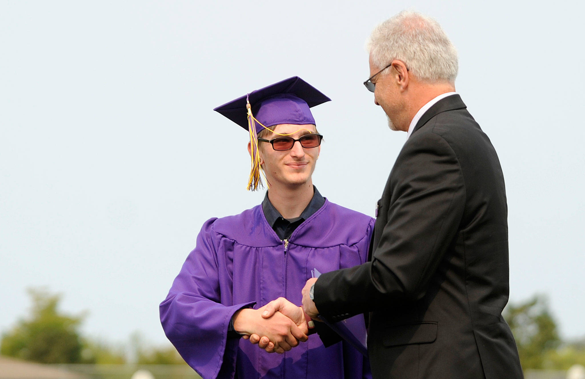 Michael Ray Barbour accepts his Sequim High School diploma from Sequim schools superintendent Gary Neal on Aug. 5. Michael Dashiell/Olympic Peninsula News Group
