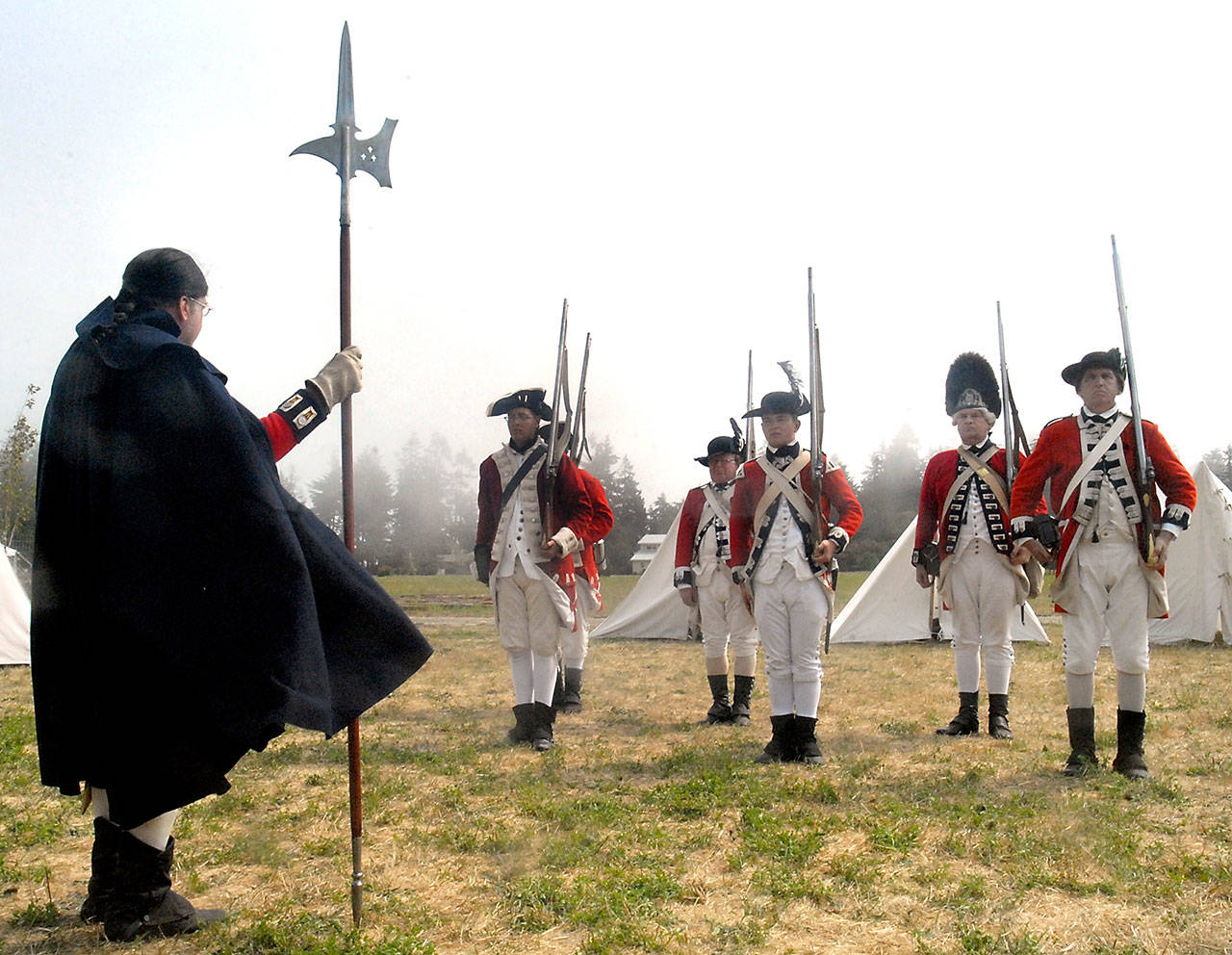 American Revolutionary War re-enactor Dennis LeMay of San Diego, Calif., left, oversees a collection of troops in a firearms drill Friday at the third annual Northwest Colonial Festival at the George Washington Inn near Agnew. The event, which continues today from 9:30 a.m. to 5:30 p.m., features a collection of re-enactors demonstrating a variety of activities, including life in the 1700s while focusing on the April 19, 1775, “Skirmish on Lexington Green” and the “Battle for Concord Bridge.” (Keith Thorpe/Peninsula Daily News)