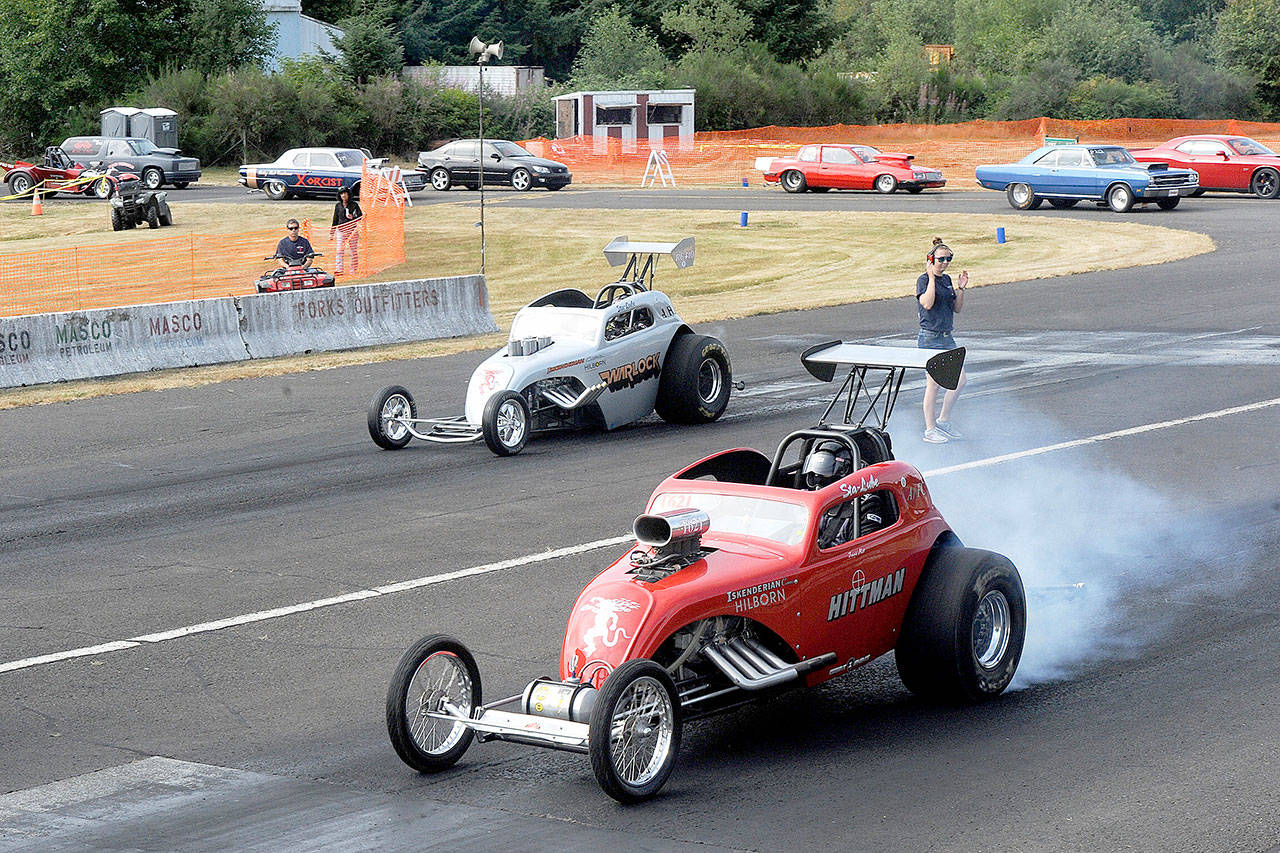 Ron Brombelow, driving the Warlock car, and Travis Hitt in the Hittman car, both of Quilcene, move up to the starting line Saturday at the Forks Airport during the West End Thunder Drag Races. The next and final race of the season is scheduled for September 23 and 24. (Lonnie Archibald/for Peninsula Daily News)