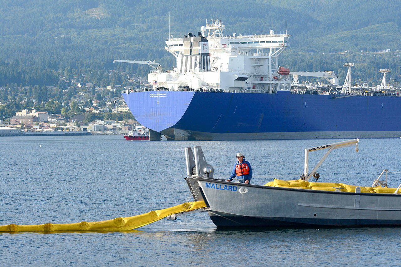 Crews unload an oil spill boom into Port Angeles Harbor during a training session Wednesday. (Jesse Major/Peninsula Daily News)
