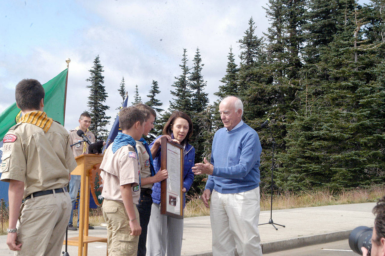 U.S. Sen. Maria Cantwell presents to former Sen. Daniel Evans a framed copy of the bill she sponsored that renamed the Olympic Wilderness as the Daniel J. Evans Wilderness during a ceremony at Hurricane Ridge on Friday. (Rob Ollikainen/Peninsula Daily News)