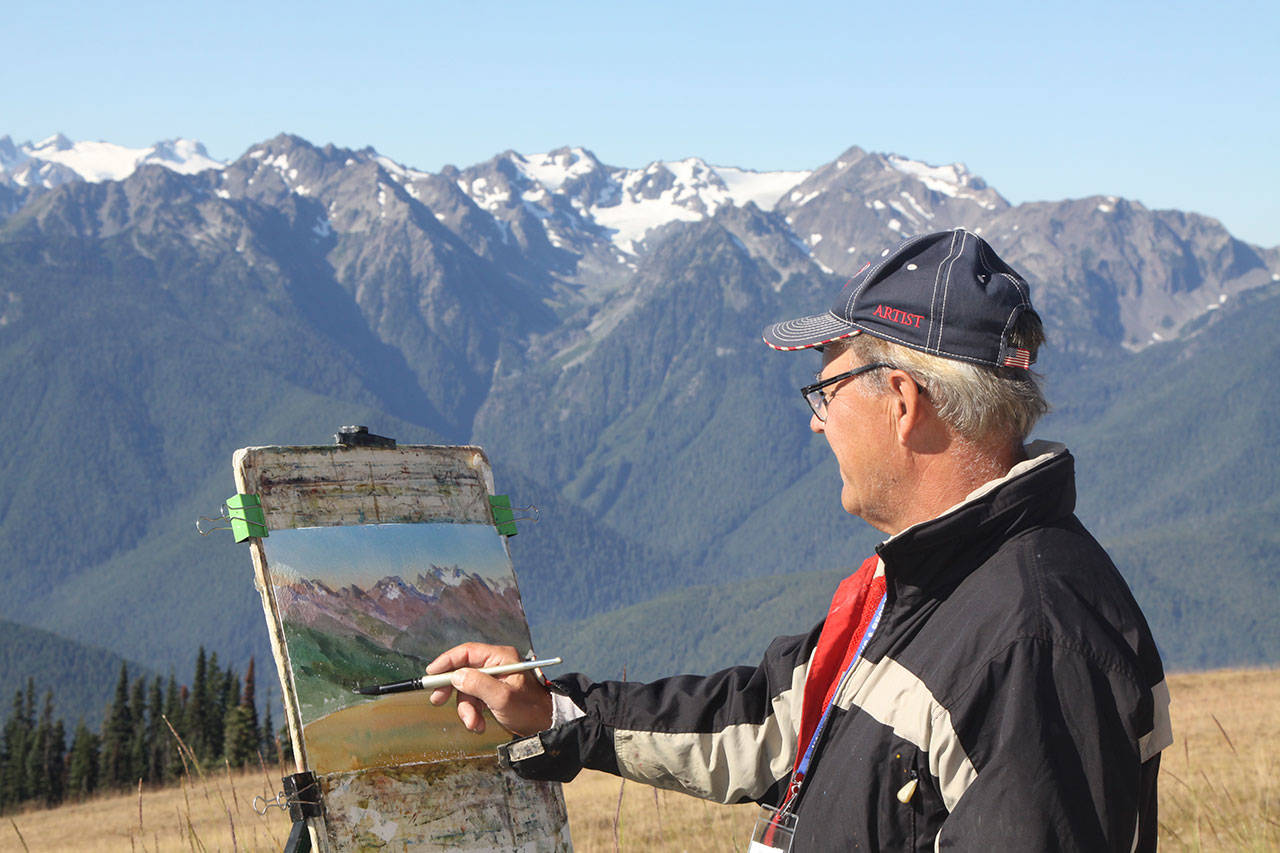Bill Rogers of Nova Scotia, Canada, paints a watercolor of the Olympics as part of last year’s Paint the Peninsula plein air competition hosted by the Port Angeles Fine Arts Center. When asked how long it takes to create a watercolor painting like this one, he replied, “Forty-five minutes plus 30 years.” (Dave Logan/for Peninsula Daily News)