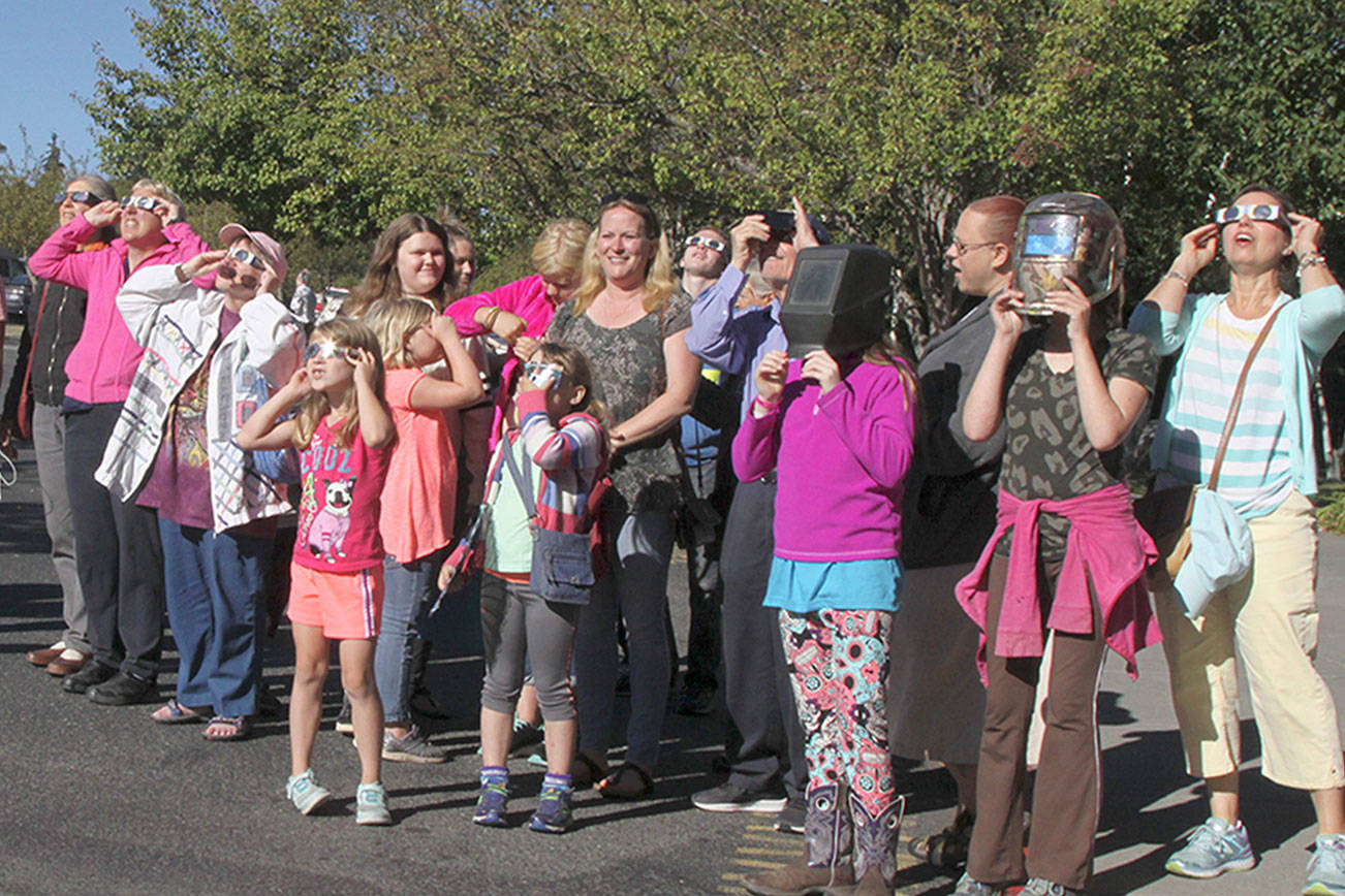 Peninsula residents gather to share glasses, gawk in awe at partial solar eclipse