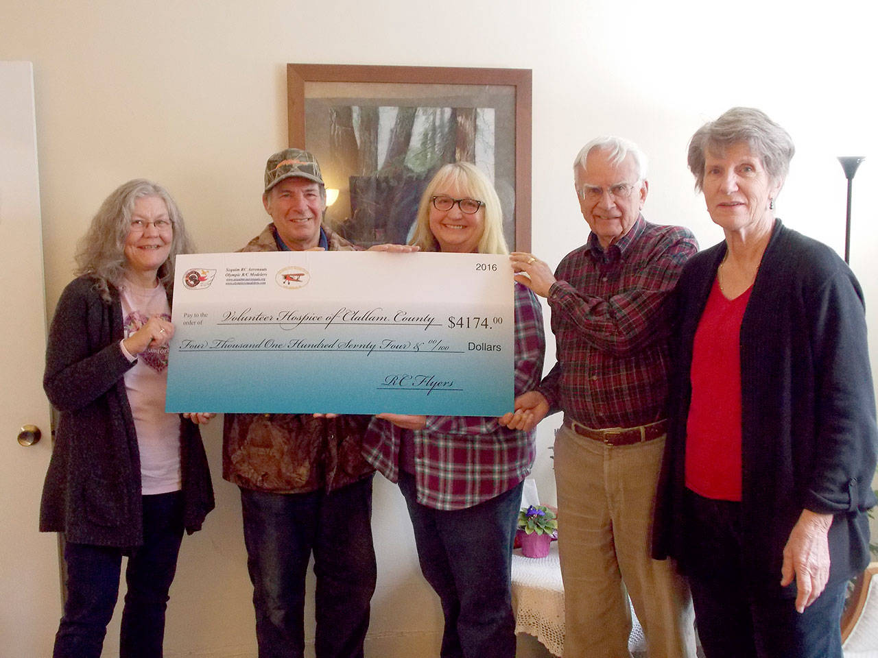 Ed Veraldi of Sequim Aeronauts and Bonnie Williams of the Olympic RC Modelers present a check for $4,174 to Bette Wood, Dave Gilbert and Lynn Gilbert of Volunteer Hospice of Clallam County — proceeds from the RC airplane demonstration and raffle held at the 2016 Air Affaire.