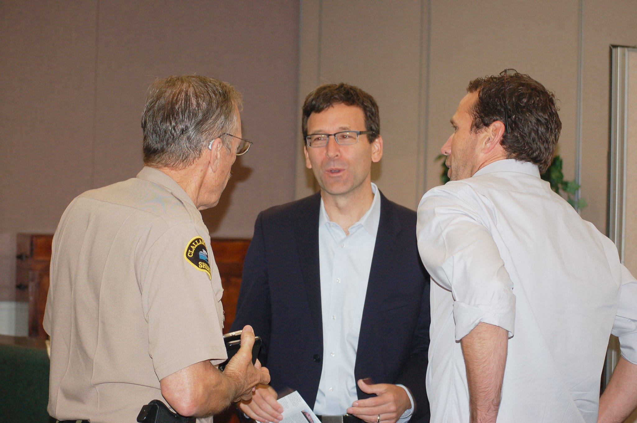 Washington State Attorney General Bob Ferguson, center, talks with Clallam County Sheriff Bill Benedict, left, and Rotary members after the Sequim Sunrise Rotary meeting last Friday, where he stopped to pay a visit on his way to the ceremony naming the Daniel J. Evans Wilderness at Hurricane Ridge. (Erin Hawkins/Olympic Peninsula News Group)