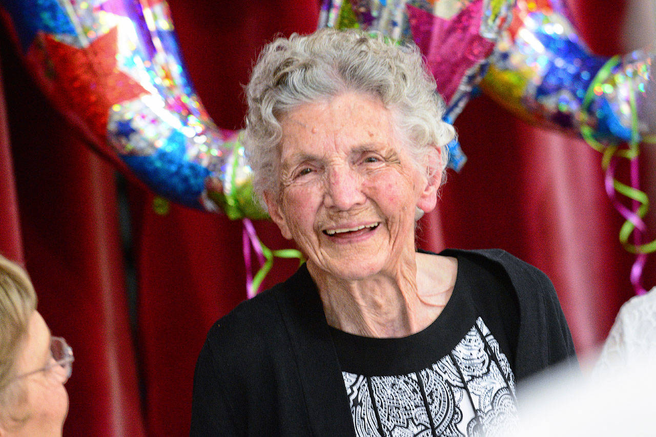 Anne Todnem smiles after singing with The Messengers during her 100th birthday party at First United Methodist Church in Port Angeles on Sunday. (Jesse Major/Peninsula Daily News)