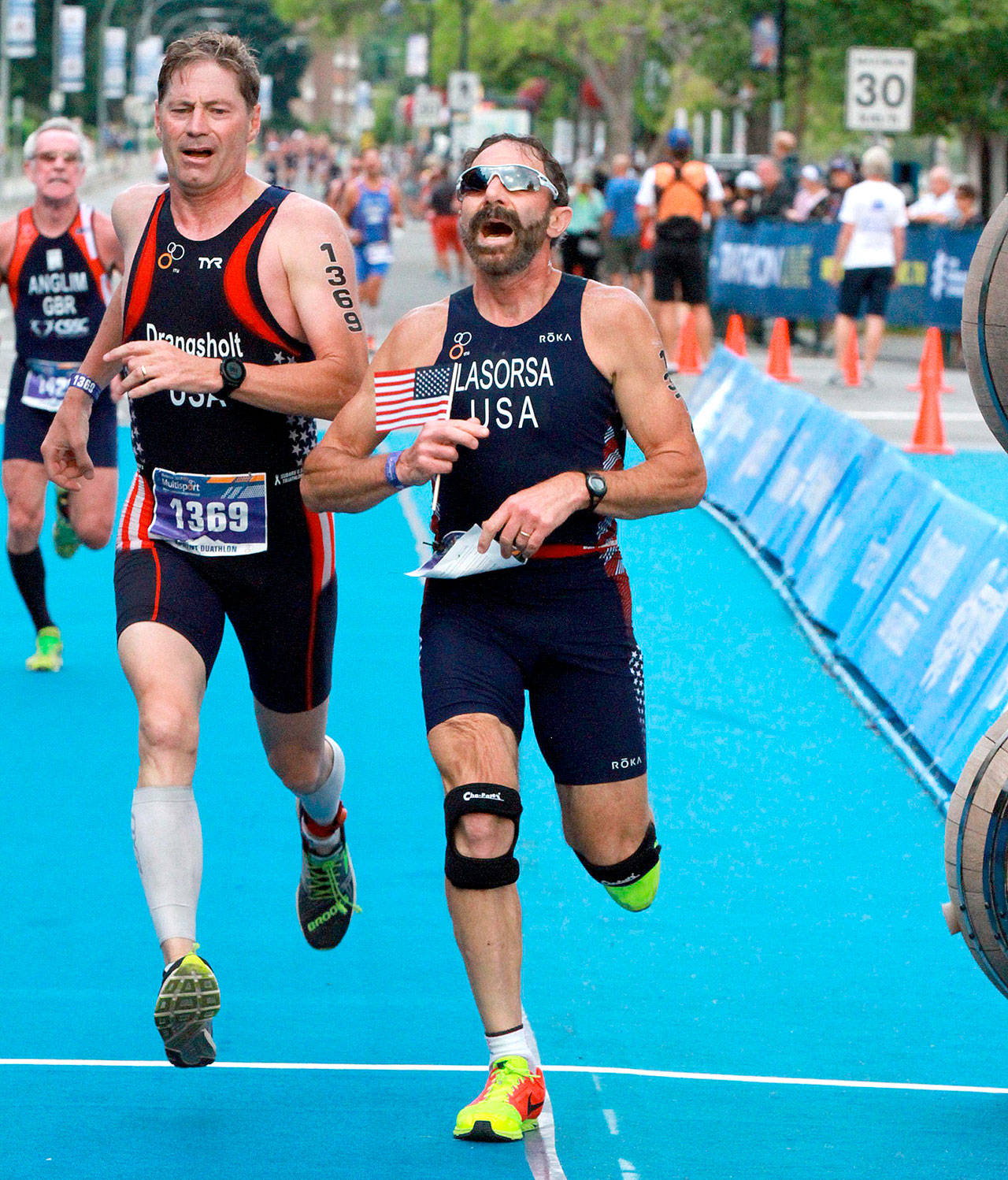 Port Angeles’ Dave Lasorsa crosses the finish line just ahead of U.S. teammate Mark Drangsholt at the World Duathlon championships held in Pentiction, B.C., on Aug. 19. Lasorsa finished 12th in the 60-64 category.