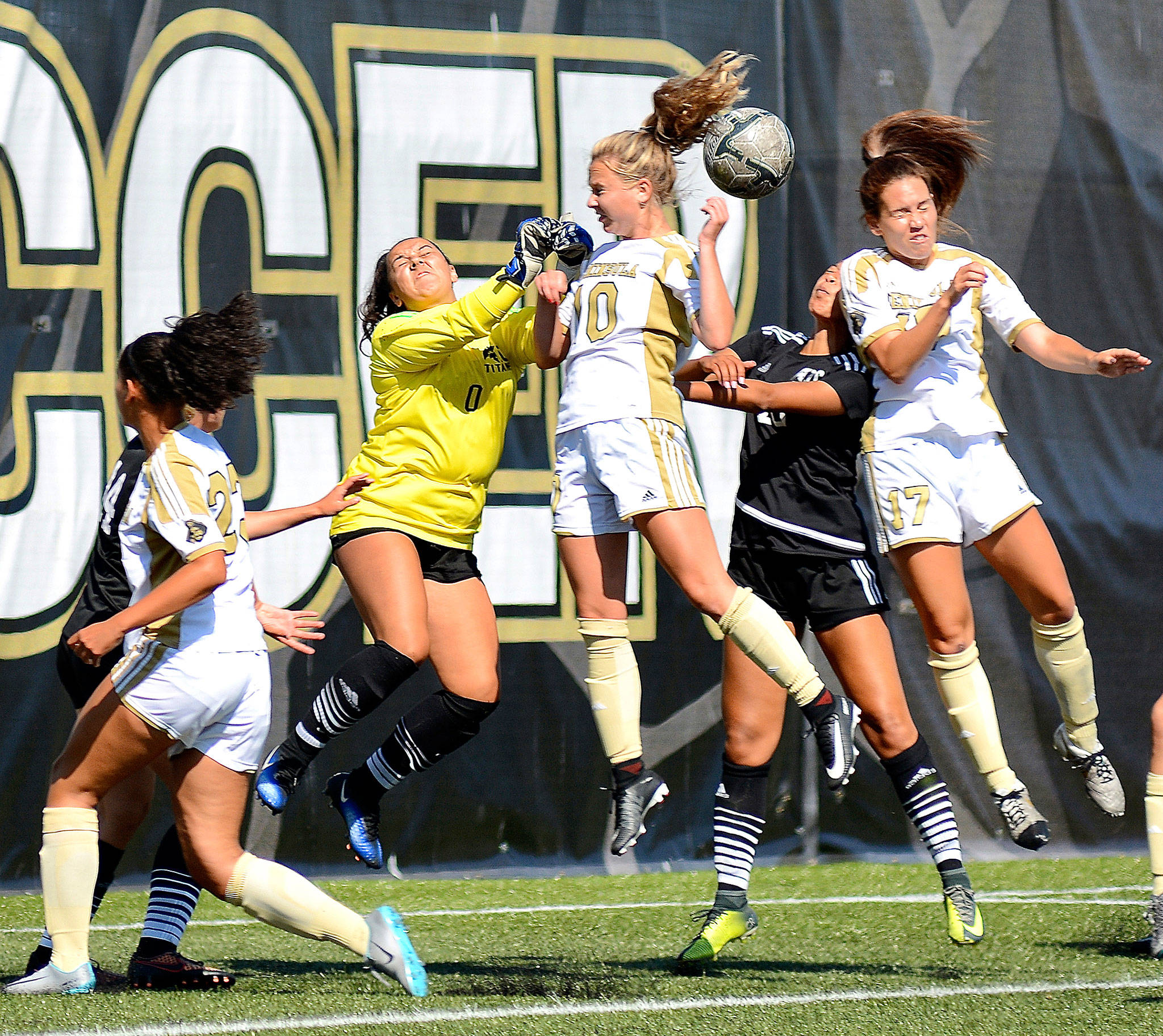 Peninsula&rsquo;s Kelly Kevershan (10) and Emelie Small (17) battle for a loose ball with Tacoma goalie Courtney Cecil in Tuesday&rsquo;s 9-0 Peninsula win. In on the play at left is Peninsula&rsquo;s Halle Watson (23). (Jay Cline/for Peninsula Daily News)