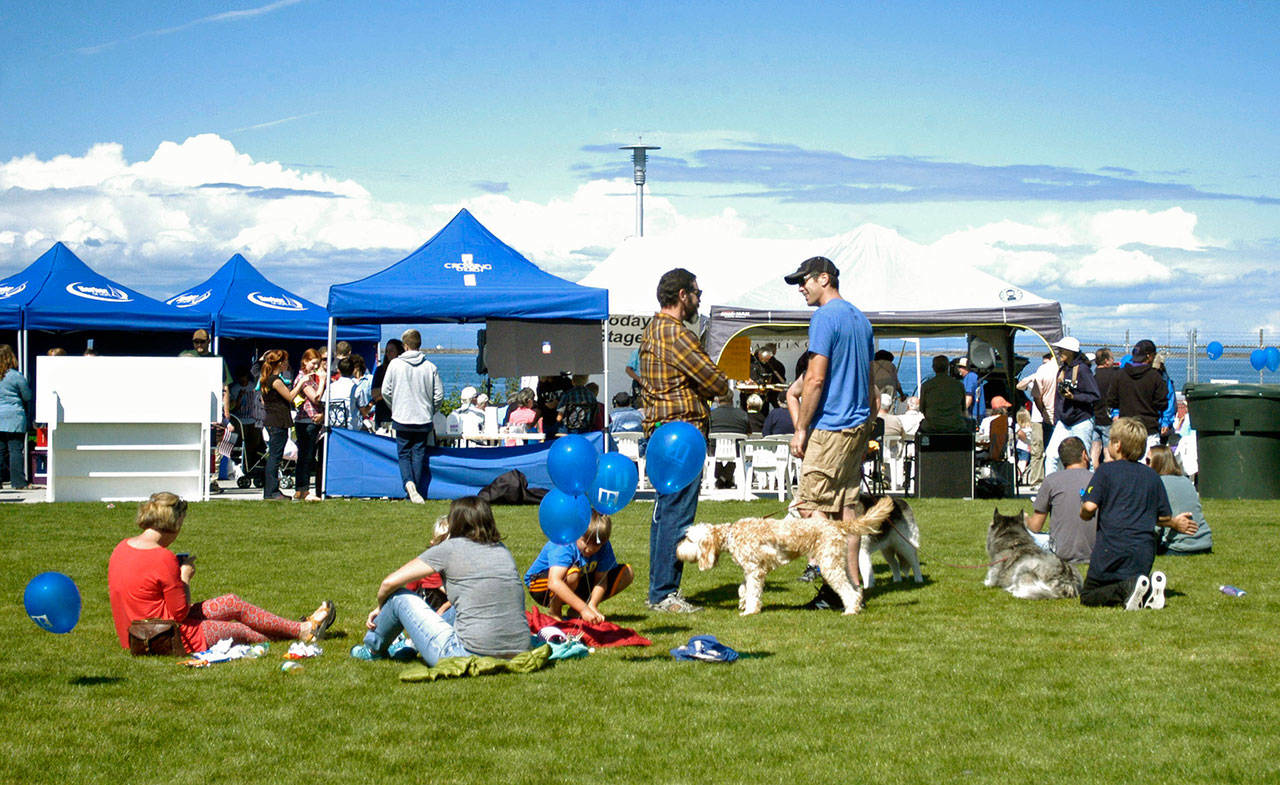 Families and their four-legged friends congregate in the grass at Waterfront Park, in downtown Port Angeles, during the 2016 Jammin’ in the Park celebration and fundraiser organized by Nor’Wester Rotary. (Peninsula Daily News)