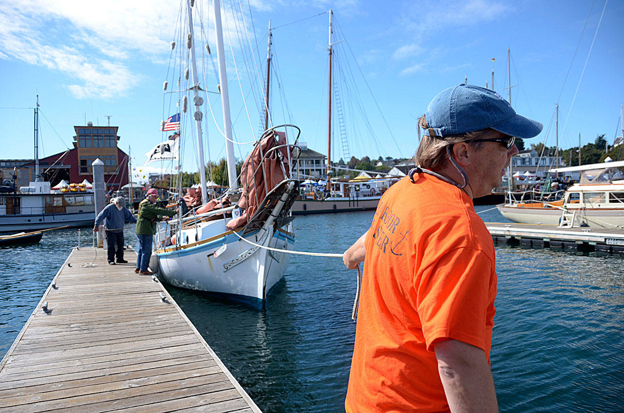 Marina crew members help dock a sailboat in Point Hudson Marina in Port Townsend at last year’s Wooden Boat Festival. (Cydney McFarland/Peninsula Daily News)