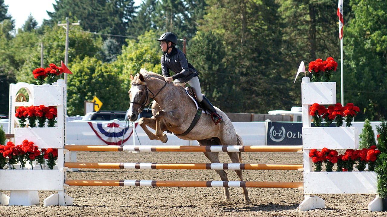 Freedom Farm’s Hoof Beat’s club member Ben Robertson makes a jump while riding Joy Ride at the Oregon Summer Classic.
